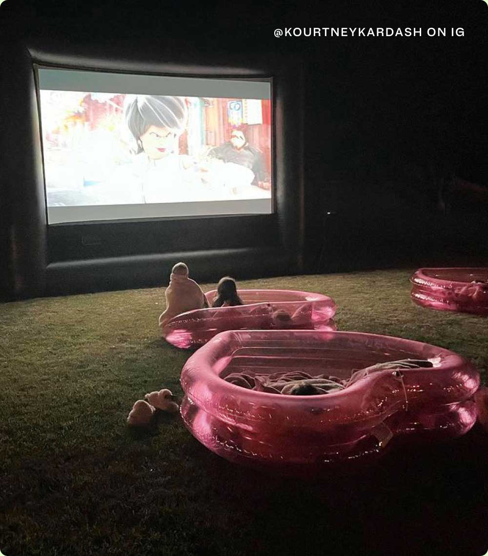 Kids enjoying an outdoor movie while in an inflatable childrens pool | @KOURTNEYKARDASH