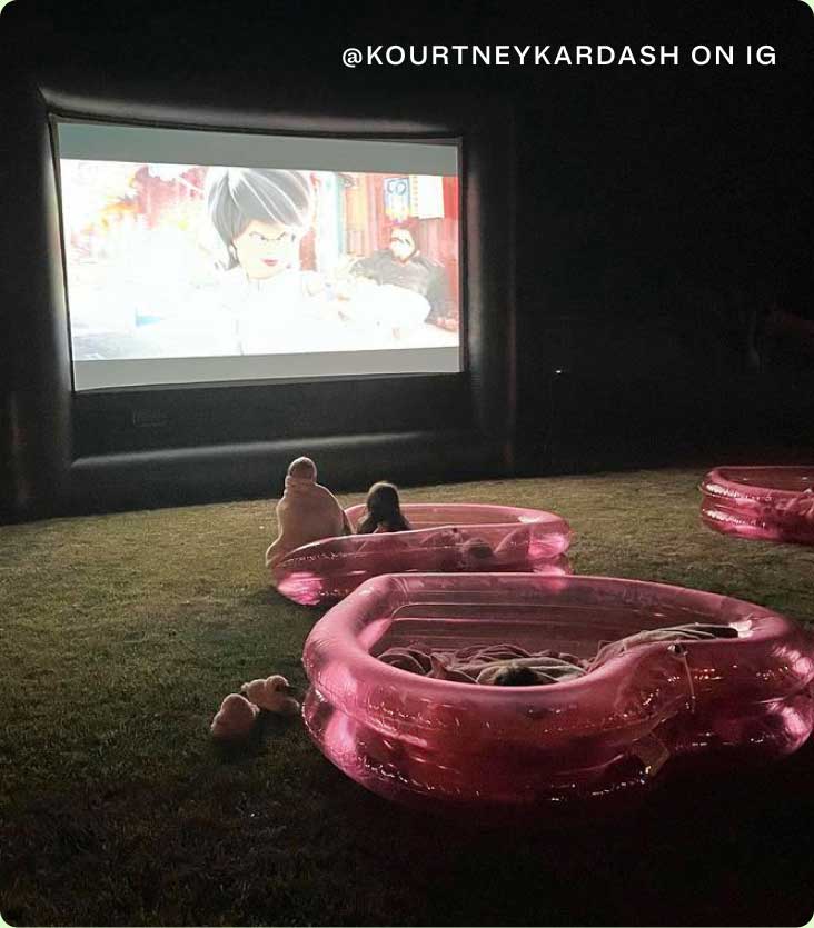 Kids enjoying an outdoor movie while in an inflatable childrens pool | @KOURTNEYKARDASH